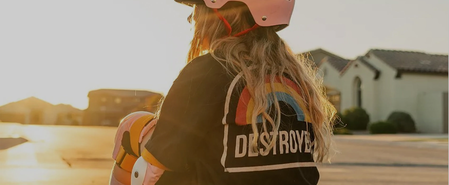Girl skateboarder wearing Destroyer t-shirt and skate protective gear